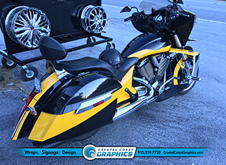 Crystal Coast Graphics installed a complete color change wrap on this yellow and black motorcycle.